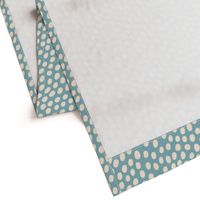 Textured cream spots on blue