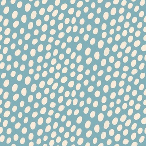 Textured cream spots on blue