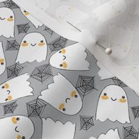 tiny halloween ghosts and webs on grey
