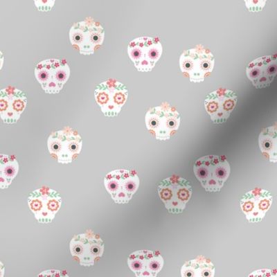 Boho dia de los muertos skulls with lush flowers and leaves Mexican halloween design pink white green on gray