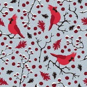 Winter scenery with red cardinals birds, red berries branches and snow on a light blue background