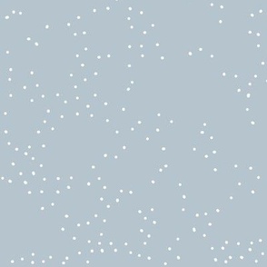 White scattered dots on a light blue background, falling snow in winter, christmas season