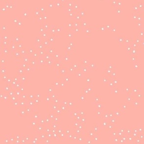 White scattered dots on a pink/salmon background, falling snow in winter, christmas season