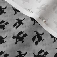 Small Scale Wicked Flying Witches Black Silhouettes on Cloudy Grey Sky