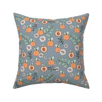 Sweet peachy fall garden leaves and peaches fruit and daisy blossom apricot green on moody blue gray
