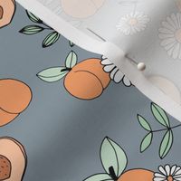 Sweet peachy fall garden leaves and peaches fruit and daisy blossom apricot green on moody blue gray