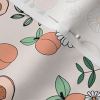 Sweet peachy fall garden leaves and peaches fruit and daisy blossom apricot orange green sage on cream sand