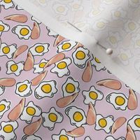 Bacon and eggs on pink background