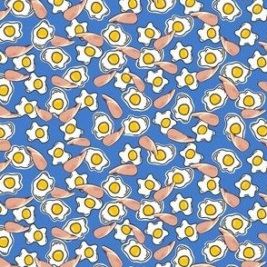 XS - Bacon & eggs fabric on blue background