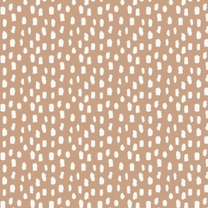 White marks on medium brown background