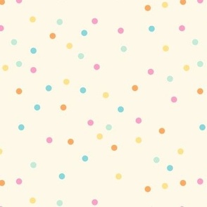 Colorful pastel dots over cream background