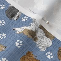 Trotting assorted Tibetan Terriers and paw prints - faux denim