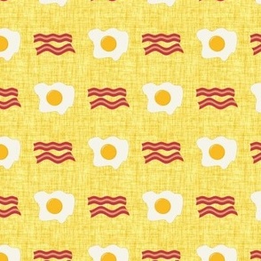Small Scale Bacon and Eggs Breakfast Foods on Yellow