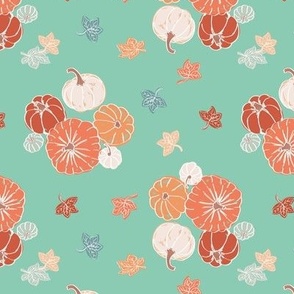 Pumpkins and leaves on mint green