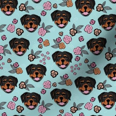 Blossom Rottweiler puppies with flowers and leaves freehand drawn dog illustration in pink gray caramel on blue
