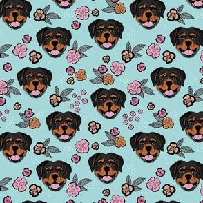 Blossom Rottweiler puppies with flowers and leaves freehand drawn dog illustration in pink gray caramel on blue