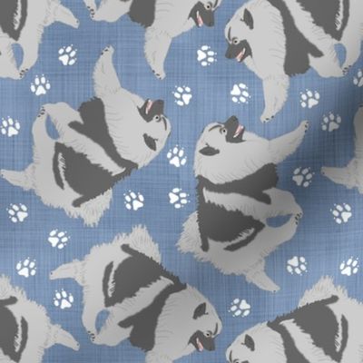 Trotting Keeshond and paw prints - faux denim