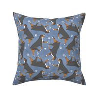 Trotting Entlebucher mountain dog and paw prints - faux denim