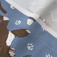 Trotting assorted Portuguese water dogs and paw prints - faux denim