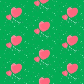 Pink heart balloons on green