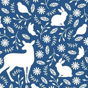 Deers, rabbits, birds, butterflies on navy blue amidst floral setting - medium scale