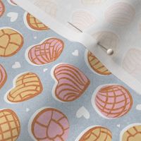 Tiny scale // Mexican pan dulce // pastel blue background pink and yellow conchas