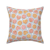 Small scale // Mexican pan dulce // pastel blue background pink and yellow conchas