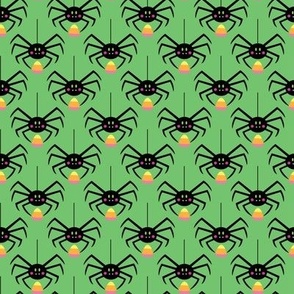 spiders with candycorn on green