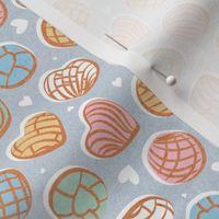 Tiny scale // Mexican pan dulce // pastel blue background multicolored conchas
