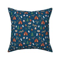 Winter wonderland camping trip outside adventures with campfire marshmallows and hot chocolate pine tree forest and wood logs green red on navy blue