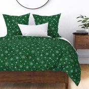 Shibori Snow and Stars on Deep Green (large scale) | Snowflakes and gold stars on arashi shibori linen pattern, block printed stars on pine forest green, Christmas fabric, winter night sky.