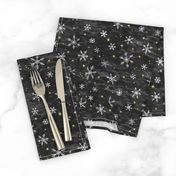 Shibori Snow and Stars in Charcoal (small scale) | Snowflakes and gold stars on arashi shibori linen pattern, block printed stars, black and gold, Christmas fabric, winter night sky.