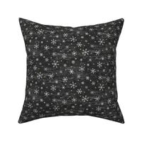 Shibori Snow and Stars in Charcoal (extra small scale) | Snowflakes and gold stars on arashi shibori linen pattern, block printed stars, black and gold, Christmas fabric, winter night sky.