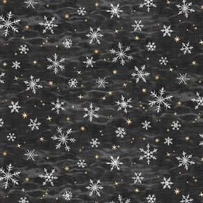 Shibori Snow and Stars in Charcoal (extra small scale) | Snowflakes and gold stars on arashi shibori linen pattern, block printed stars, black and gold, Christmas fabric, winter night sky.