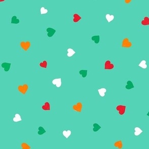 Small hearts in red, white and orange on a green background