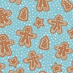 Little Christmas cookies and gingerbread men in ginger cinnamon on teal blue