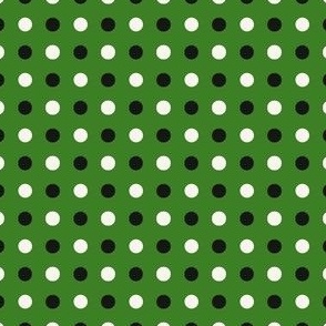 black and cream polka dots on green