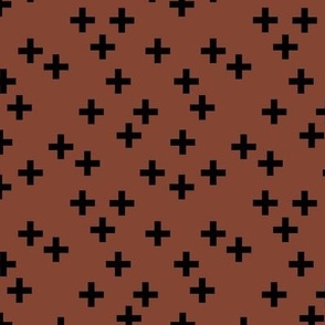 Geometric plus Scandinavian abstract sign design little cross black on spice rust