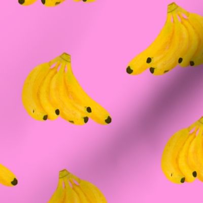 Yellow bananas bunches pink background 
