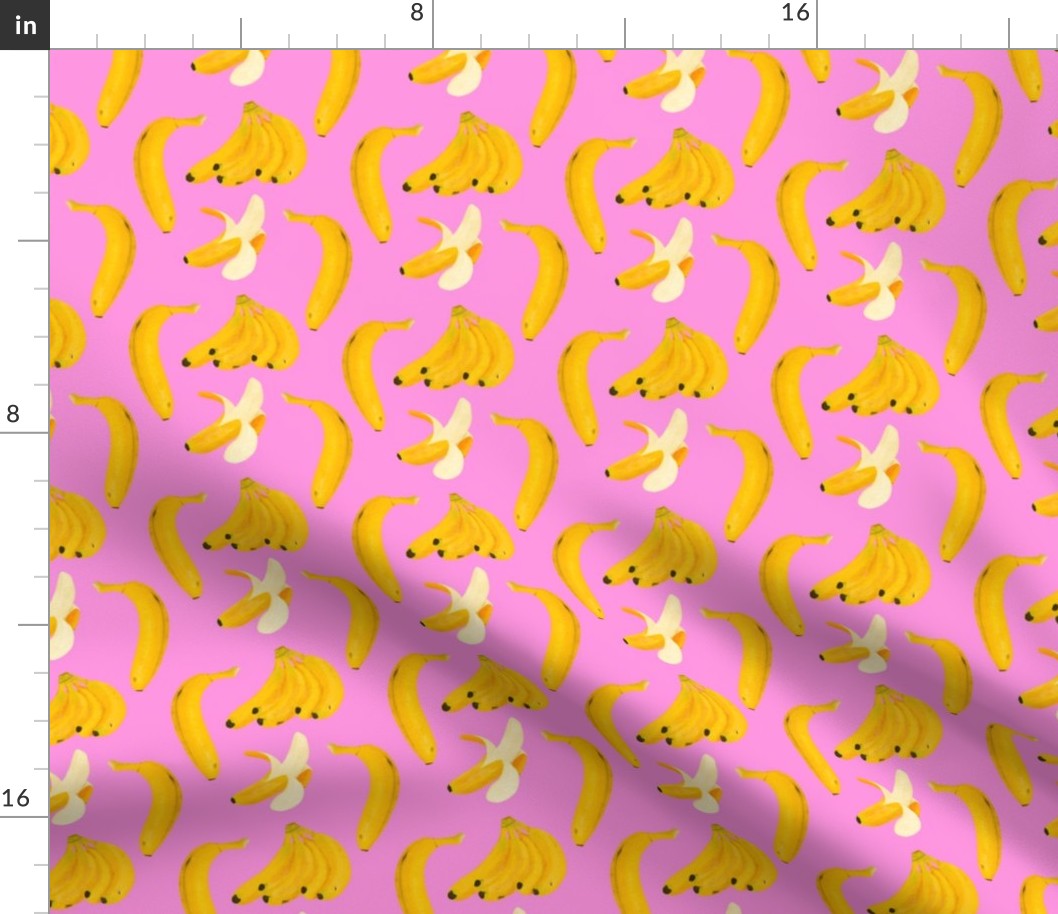 Yellow bananas assorted on pink background 