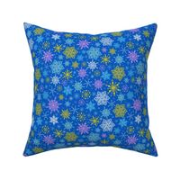 Colorful snowflakes on blue fabric design repeat pattern