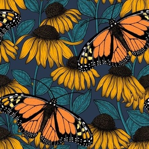 Monarch butterflies on yellow coneflowers  on navy