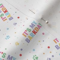Colorful rainbow barkday design with confetti paws and happy birthday text for dogs on white 