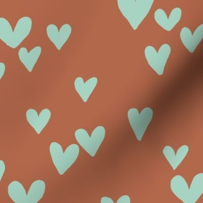 Solid hearts for valentine minimalist heart shapes pattern nursery texture mint green on rust brown