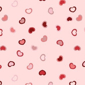 Scattered Hearts in a red to pink ombre on a light pink background