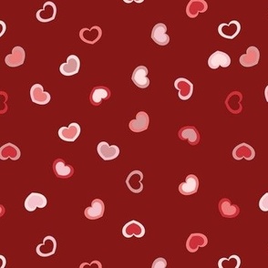 Scattered Hearts in a red to pink ombre on a dark red background