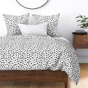 Abstract black and white cat paw pattern with dots