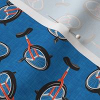 Unicycles - orange on blue - bike sports - LAD21