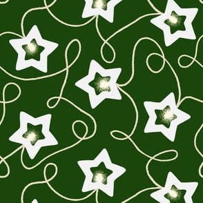 Scattered Star Christmas String Light decoration on green