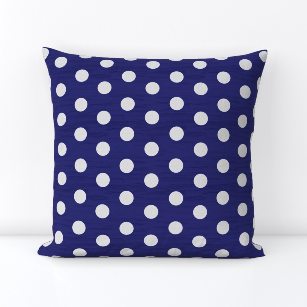 Dark blue rock wall with white linen polka dots